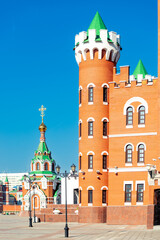 Tower of the Republican Puppet Theater in Yoshkar-Ola and the Chapel of Peter and Fevronia of Murom. Russia