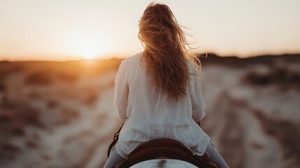 A woman rides gracefully into the sunset, embodying freedom and tranquility as the golden light casts warm hues over the landscape, creating a serene moment.
