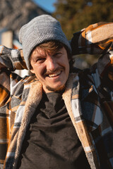 Happy Man in Plaid warm Shirt and Beanie in Suburban Setting