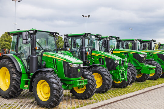 Multiple John Deere farm tractors parked in row at dealership lot. Kaunas, Lithuania, 19 June 2025