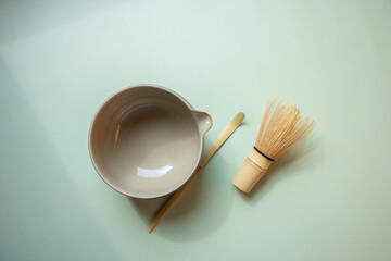 The Matcha green tea on a pastel green background, shot in still life style.