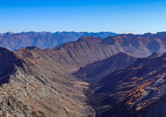 Aerial view of a mountain range with a clear blue sky on a bright sunny day outdoors