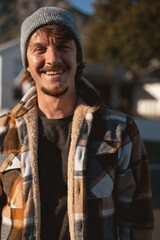 Happy Man in Plaid warm Shirt and Beanie in Suburban Setting