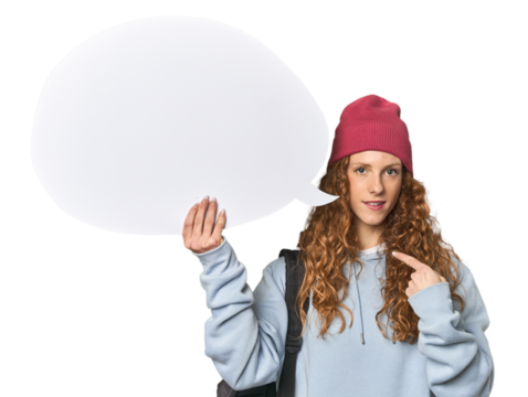 Redhead holding a comic speech bubble person pointing by hand to a shirt copy space, proud and confident