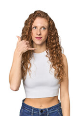 Simple redhead studio portrait laughs out loudly keeping hand on chest.