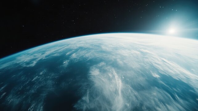 A breathtaking perspective of Earth captured from space revealing the majestic blue atmosphere and wispy clouds under the vast, starry cosmos and radiant sunlight.