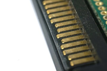 Close-up of gold connectors on a circuit board.  Ideal for tech, electronics, and repair concepts.