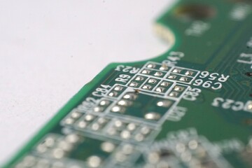 Close-up shot of a green circuit board's intricate details, showcasing soldered components and...