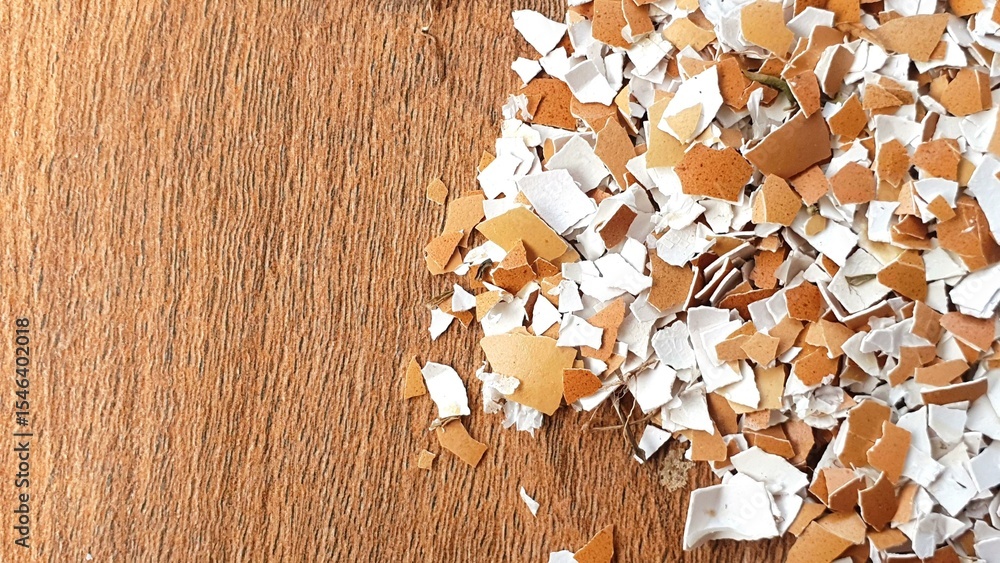 Poster scattered eggshells on a brown surface. close-up shot of broken eggshells, showing texture and color