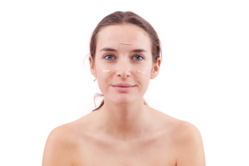Smiling young woman with natural skin applying foundation cream on face. Visible makeup strokes. Beauty portrait, isolated on white background. Skincare and cosmetics routine, natural look concept.