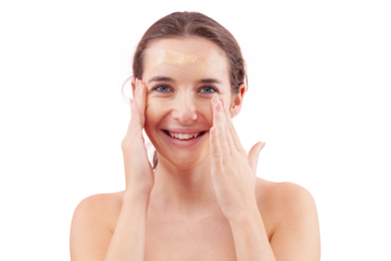 Smiling young woman with natural skin applying foundation cream on face. Visible makeup strokes. Beauty portrait, isolated on white background. Skincare and cosmetics routine, natural look concept.