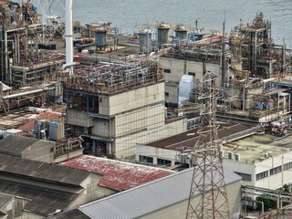 Industrial chemical plant in Kawasaki, Japan with complex pipe systems and smokestacks
