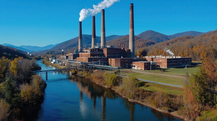 Obraz premium Industrial building factory river autumn mountain smoke blue sky reflection landscape outdoor
