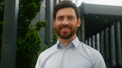Business portrait man businessman guy male look away thinking in city looking at camera smiling happy positive employer mature entrepreneur outside office professional posing near company work success
