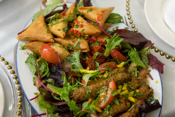 Delicious Indian Platter with Samosas Kebabs and Salad
