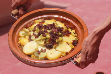 Hands Holding a Fresh Moroccan Tajine