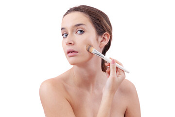 Young woman with natural skin applying foundation with a makeup brush, visible streak on cheek....