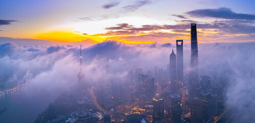 Aerial view of Shanghai skyline with flame clouds at sunrise.