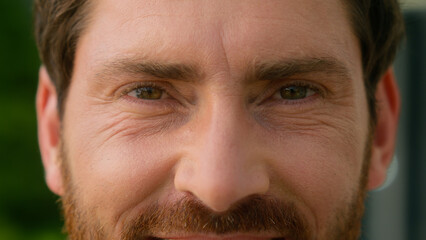 Obraz premium Extreme close up eyes wrinkled skin face of happy smiling pensive Caucasian middle-aged businessman adult business man male guy in city look away looking at camera health vision cataract medicine