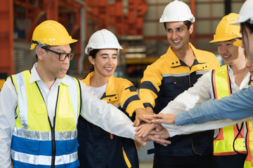 Workers, teamwork and cooperation. Workers join their hands together in industry factory. Unity and teamwork concept