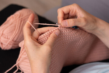 Woman crocheting. Hands closeup. Creativity, craft and hobby. Home photo