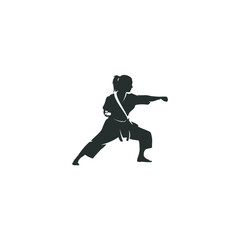 Female karate fighter silhouette in uniform performing punching technique professionally
