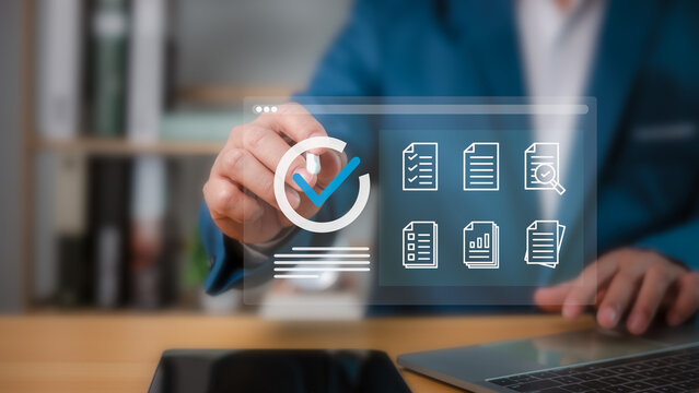Businessman checklist and filling survey form online,  Audit business concept, Compliance with internal organization financial services regulation, Examination for business and financial management.