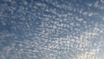 A beautiful view of cirrocumulus clouds in a blue sky.