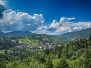 Fototapeta premium Scenic View of the Carpathian Mountains Covered by Clouds on a Sunny Day