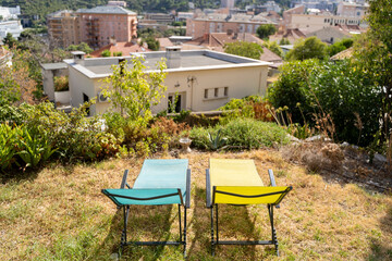 Enjoy a serene and relaxing outdoor retreat that features colorful sun loungers along with a...