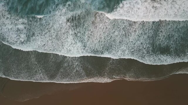 Ocean waves gently rolling onto sandy beach