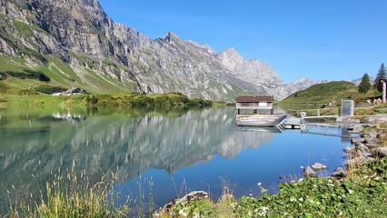 Tr&uuml;bsee Engelberg Switzerland: Turquoise clear blue mountain lake in the swiss alps with amazing water reflection	