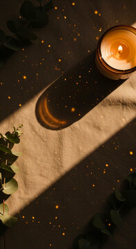 Flickering Candle with Eucalyptus on Linen Bokeh Lights Effect &ndash; Warm Boho Calm Mood Vertical