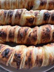 Khachapuri on skewers. Brined Suluguni cheese wrapped in puff pastry on coals