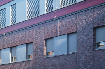 Modern building exterior showing external venetian blinds providing shade and privacy