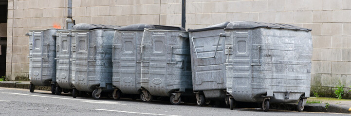 Wheelie bins in row for refuge collection outdoors