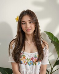 Young woman with floral embroidery and flower in her hair