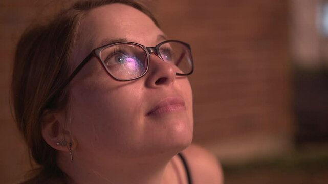 Young female watching firework explosions in sky 4k
