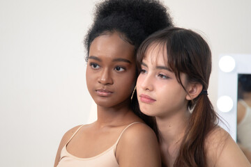 Beauty, skincare, wellness, comparison, multicultural young women with different skin tones bonding...