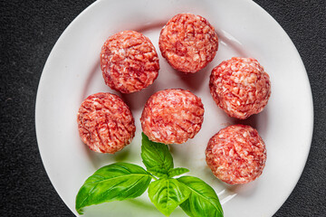 Meatballs raw meat pork, beef, chicken fresh delicious gourmet food background on the table rustic...