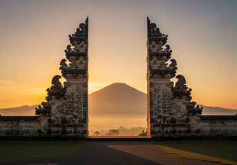 The gate of Lempuyang Temple in Bali at sunrise, framing Mount Agung amidst the mystical mistis
