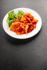 Kimchi pickled cabbage salad spicy savory vegetables fresh delicious gourmet food background on the table rustic food top view copy space vegetarian and vegan food