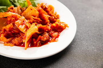 Kimchi pickled cabbage salad spicy savory vegetables fresh delicious gourmet food background on the table rustic food top view copy space vegetarian and vegan food