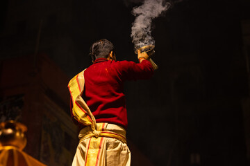 Ganga aarti, Portrait of an young unidentified male priest performing holy river ganga evening...