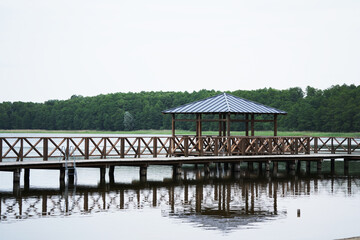Wooden pier with gazebo on quiet scenic lake