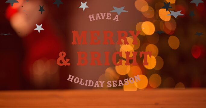 Naklejki Projecting festive greeting text over wooden tabletop, with decorative stars and blurred lights