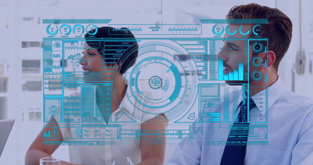 Discussing colleagues analyzing transparent dashboard interface in conference room, with laptop