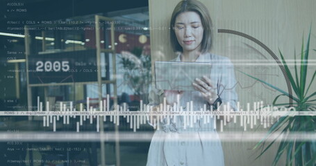 Analyzing businesswoman reviewing tablet data at office lounge, with chart overlays and coffee cups