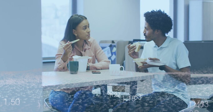 Chatting coworkers eating lunch in office break room, with takeout box, chopsticks and fork
