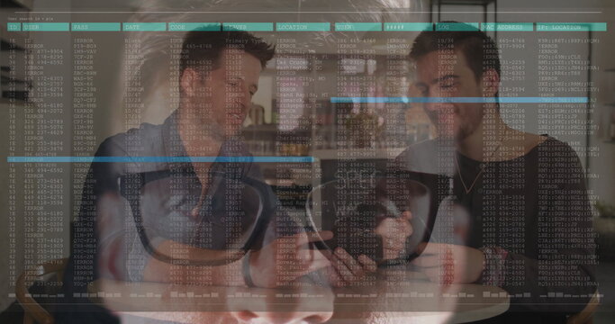 Leaning friends examining smartphone at coffee shop, with coffee mugs, VR headset, code overlay